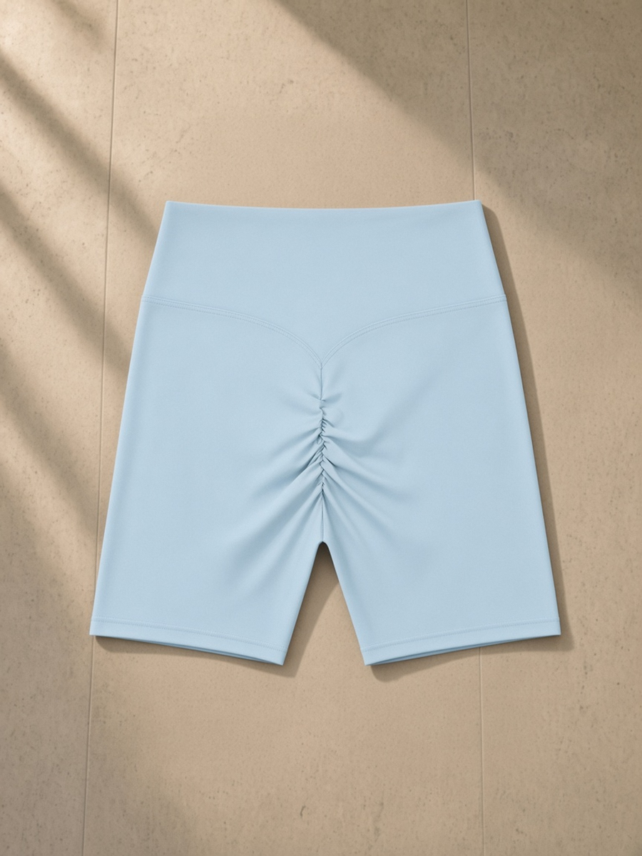 High-Waisted Blend Biker Shorts in Sky Blue, laid flat on pale limestone, back.