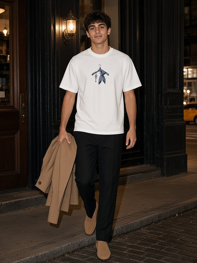 Man in the New York Coat Check tee in White stepping out of a Tribeca restaurant in New York after dinner, coat in hand
