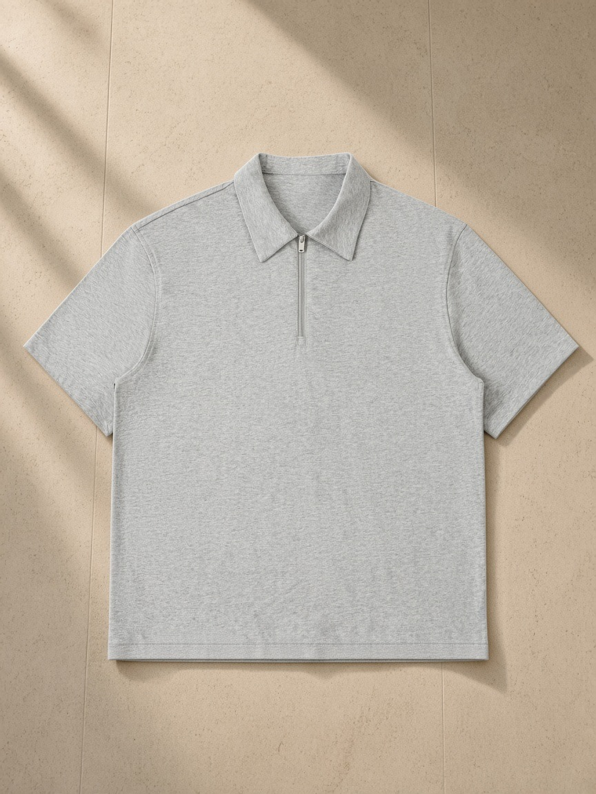 Half-Zip Cotton Polo in Flower Gray, laid flat on pale limestone