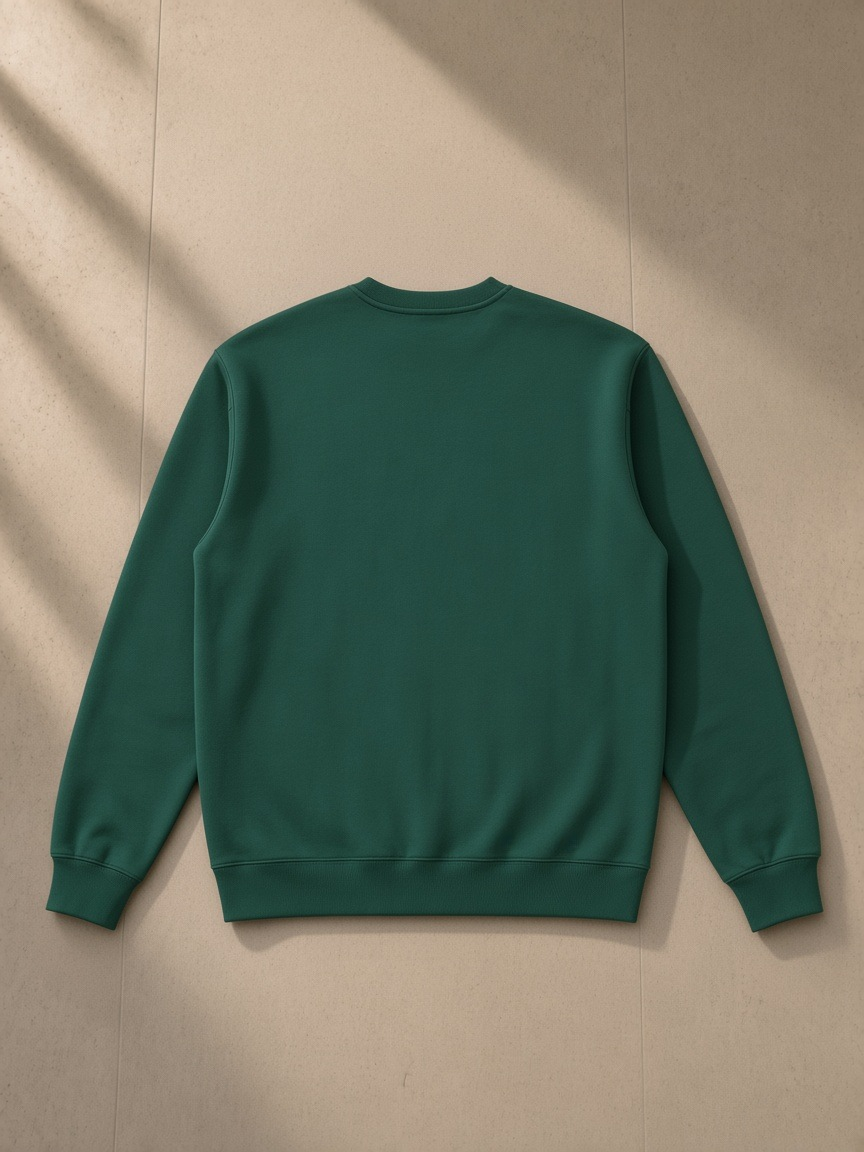 Essential heavyweight crewneck sweatshirt in Dark Green, laid flat on pale limestone, back view