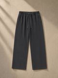 Vintage Washed Waist Pants in Washed Black, laid flat on pale limestone