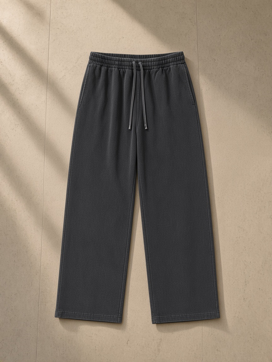 Vintage Washed Waist Pants in Washed Black, laid flat on pale limestone