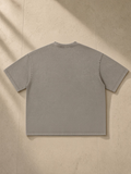 Vintage Wash Boxy T-Shirt in Light Coffee, laid flat on pale limestone, back.