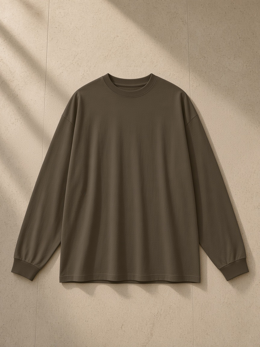 Oversized Long Sleeve T-Shirt in Brown, laid flat on pale limestone