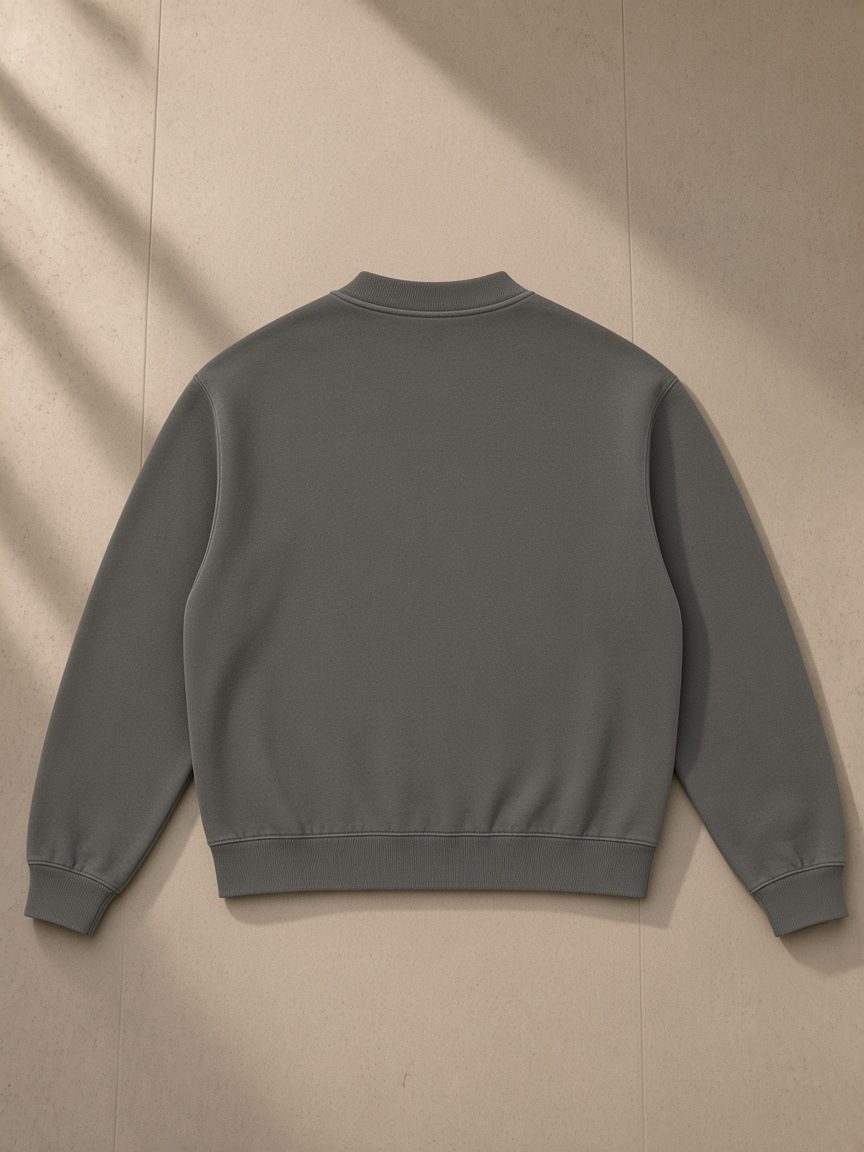 Unisex vintage wash fleece quarter zip sweatshirt in Gray, laid flat on pale limestone, back view