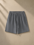 Vintage wash cotton shorts in Gray, laid flat on pale limestone