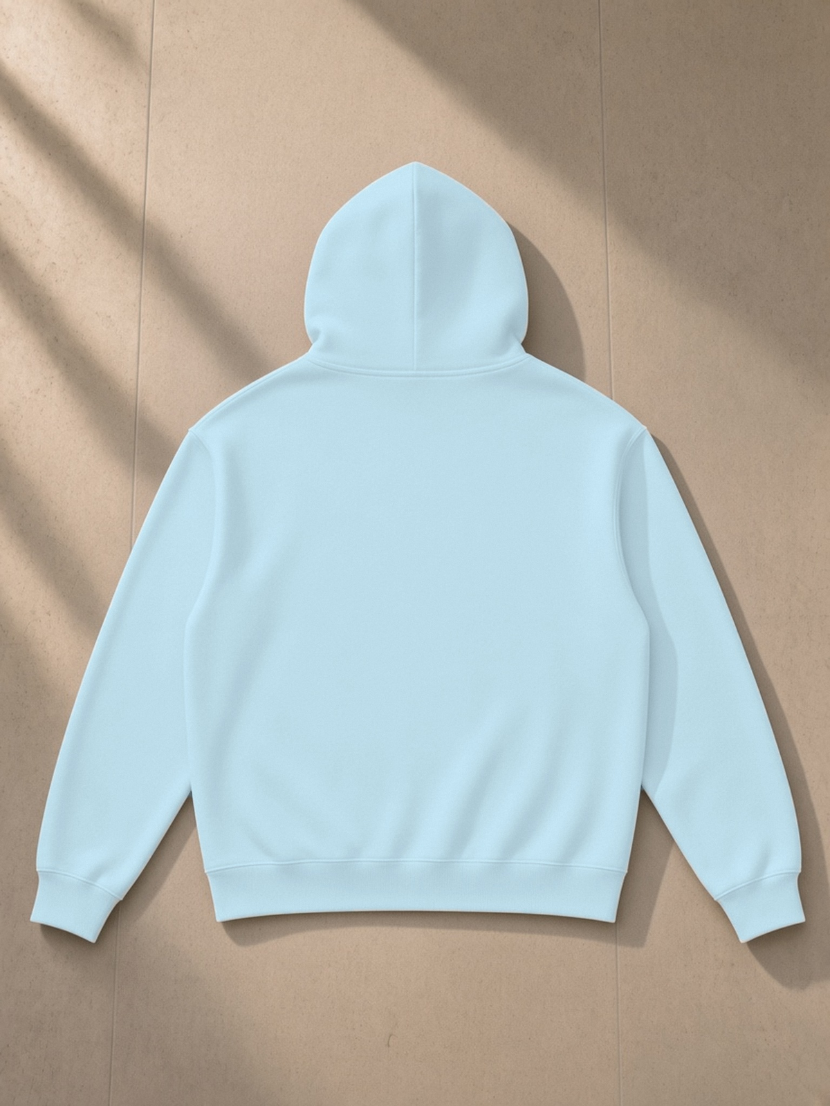 Essential Heavyweight Drop-Shoulder Hoodie in Sky Blue, laid flat on pale limestone, back.
