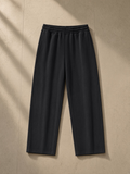 Mineral Wash Straight Sweatpants in Black, laid flat on pale limestone