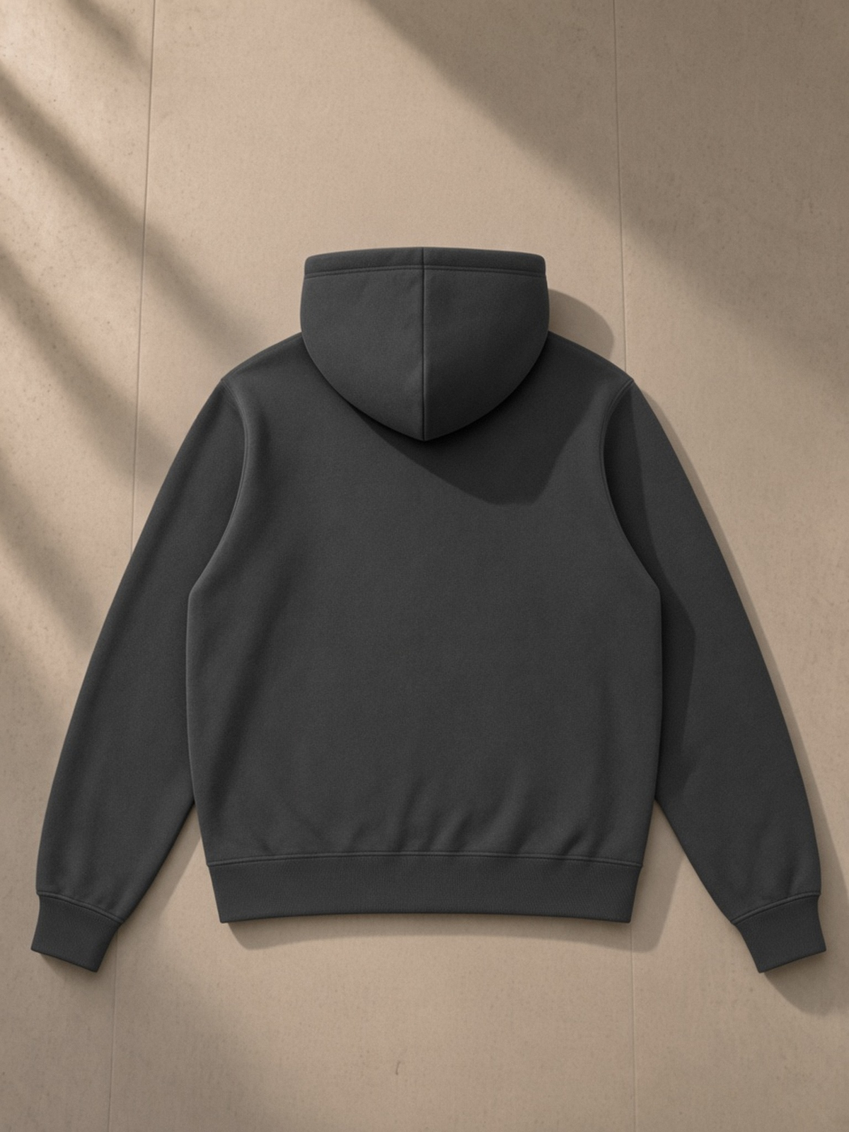 Fleece Full Zip Hoodie in Dark Gray, laid flat on pale limestone, back.