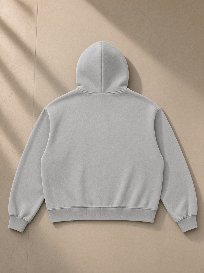 Vintage Wash Boxy Fleece Hoodie in Light Gray, laid flat on pale limestone, back view