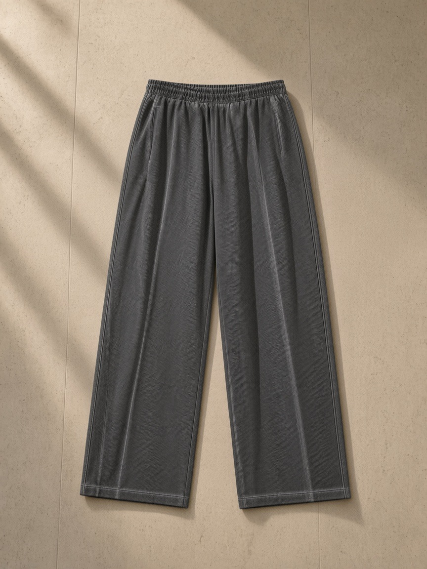 Vintage wash wide leg mesh sweatpants in Dark Gray, laid flat on pale limestone