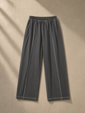Vintage wash wide leg mesh sweatpants in Dark Gray, laid flat on pale limestone