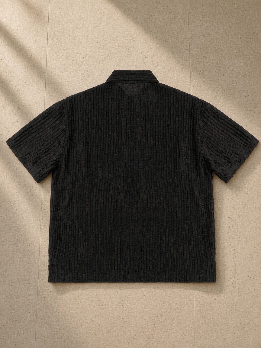Tencel Jacquard Shirt in Black, laid flat on pale limestone, back view