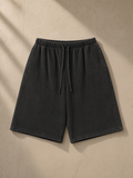 Snow Washed Raw Hem Shorts in Black, front view