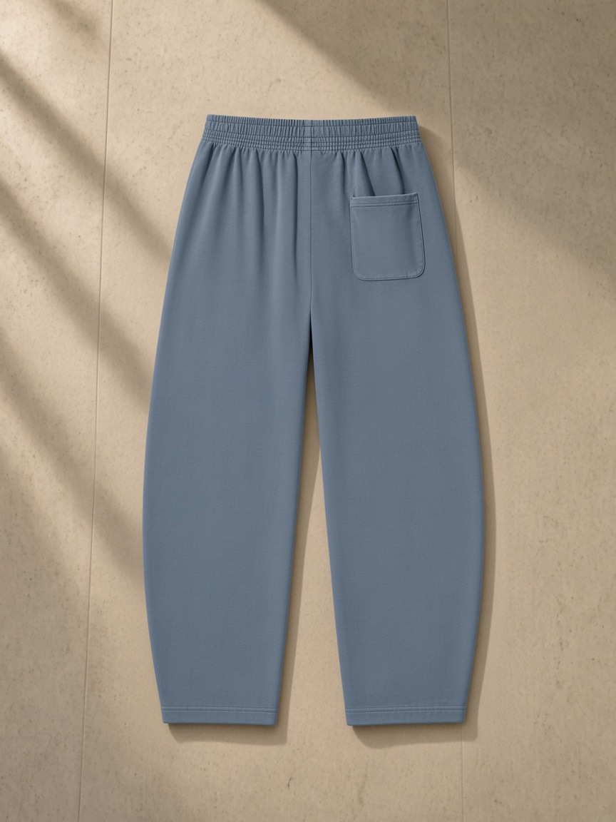 Vintage Washed Barrel Leg Sweatpants in Gray Blue, laid flat on pale limestone, back.