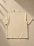 Mineral Wash Waffle Knit T-Shirt in Light Apricot, laid flat on pale limestone