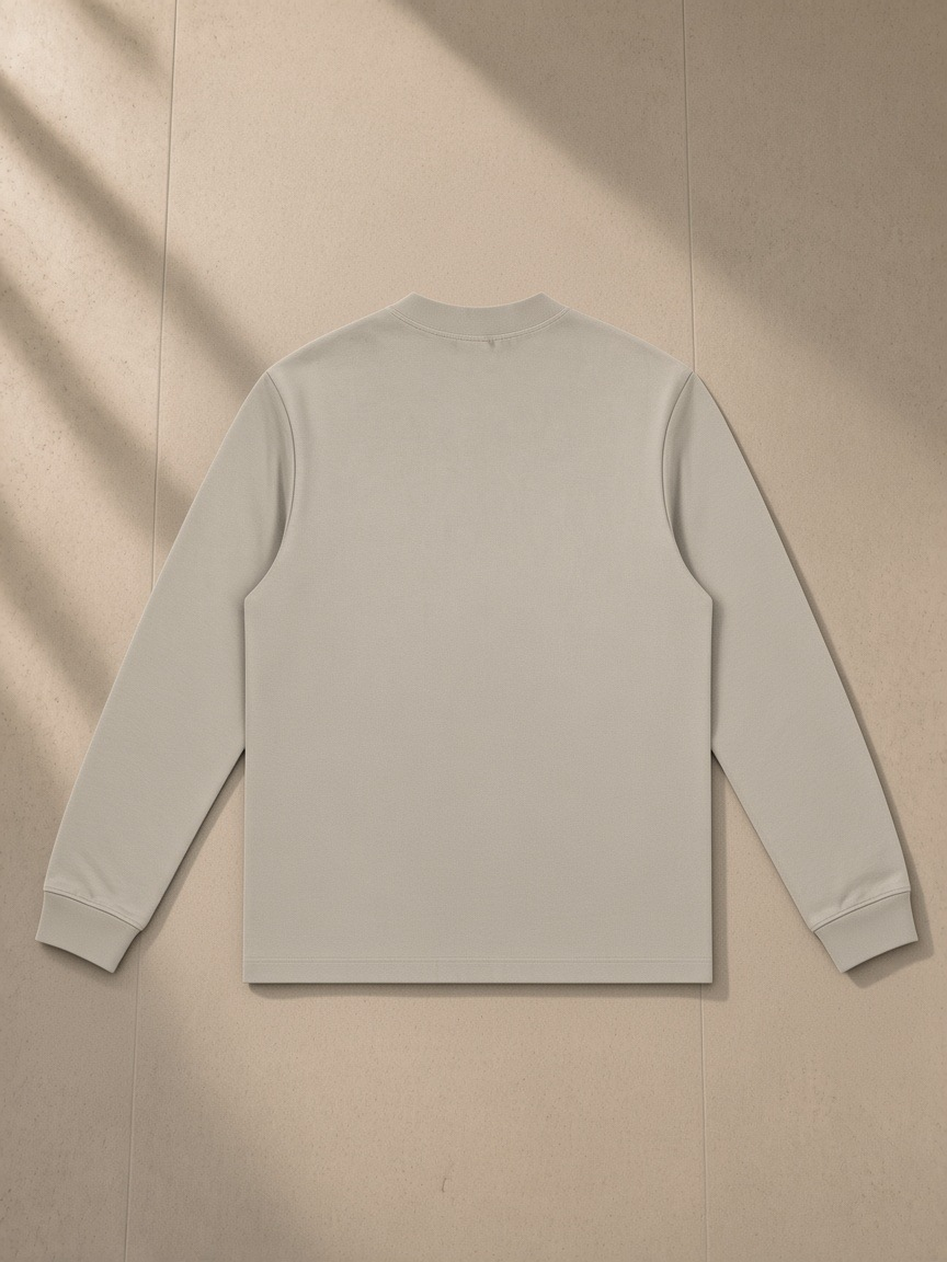 Mock Neck Sweatshirt in Light Apricot, laid flat on pale limestone, back view