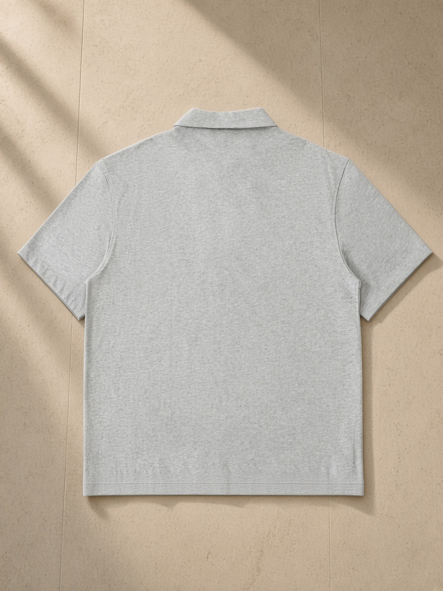 Half-Zip Cotton Polo in Flower Gray, laid flat on pale limestone, back view