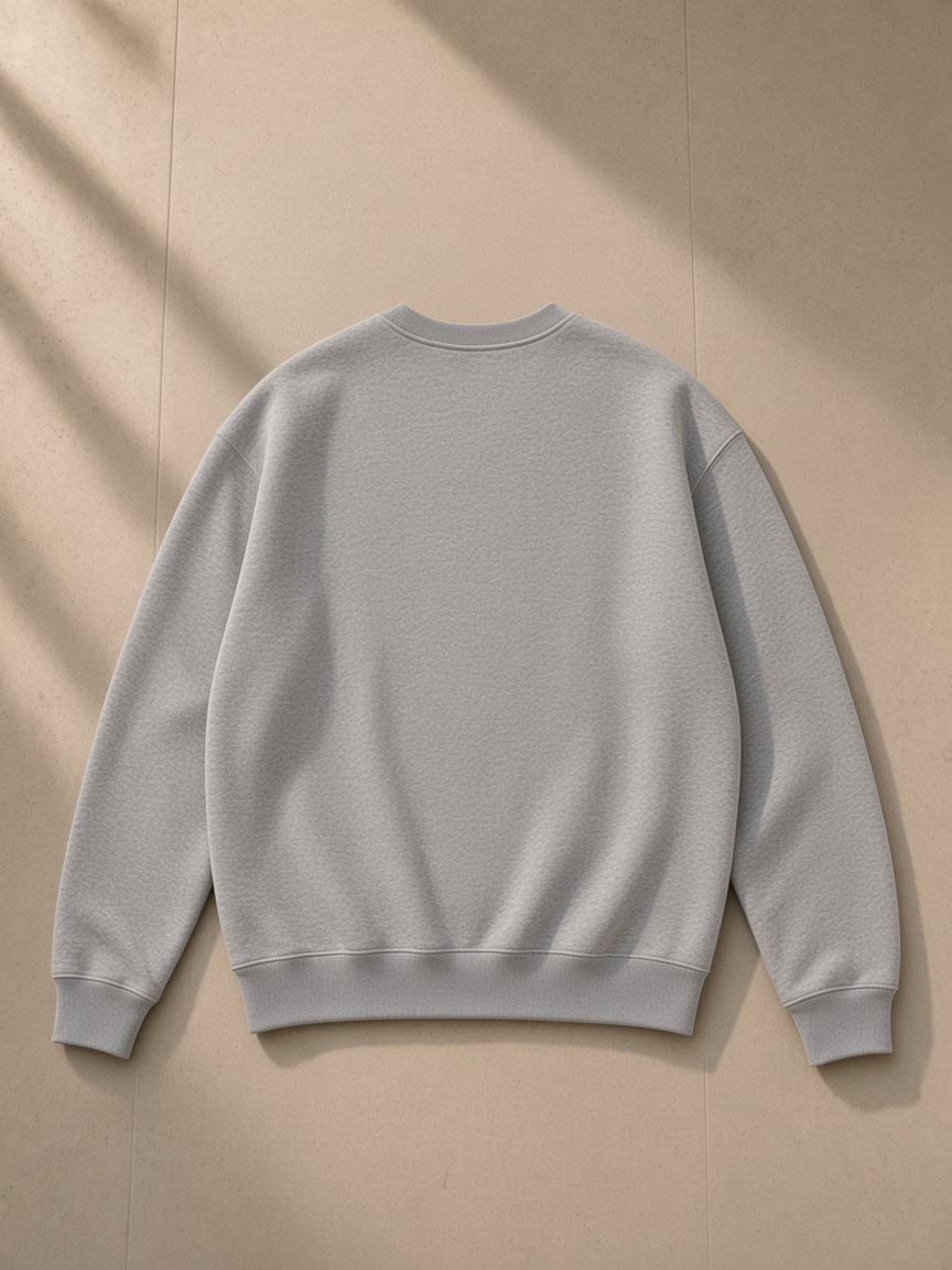 Fleeced sweatshirt in Flower Gray, laid flat on pale limestone, back view