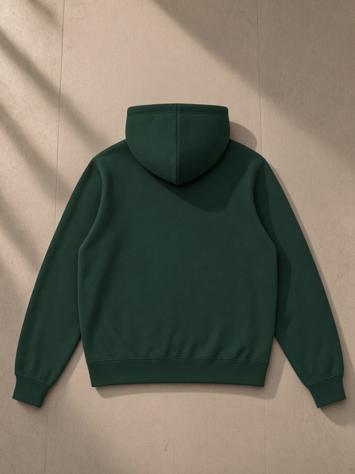 Fleece Full Zip Hoodie in Dark Green, laid flat on pale limestone, back.