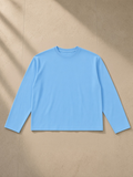Vintage Wash Long Sleeve Boxy T-Shirt in Sky Blue, laid flat on pale limestone