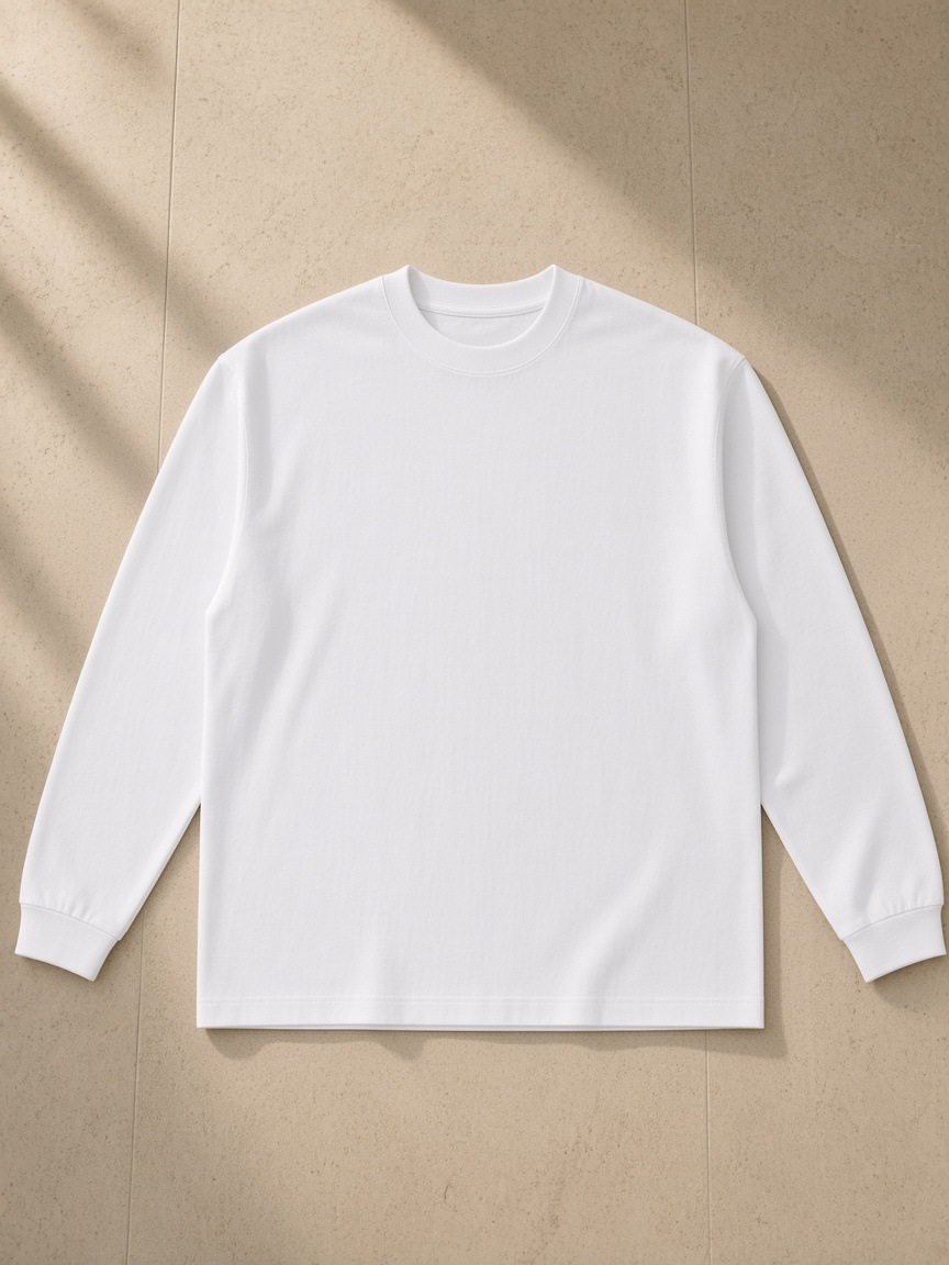 Essential Cotton Long Sleeve T-Shirt in White, laid flat on pale limestone