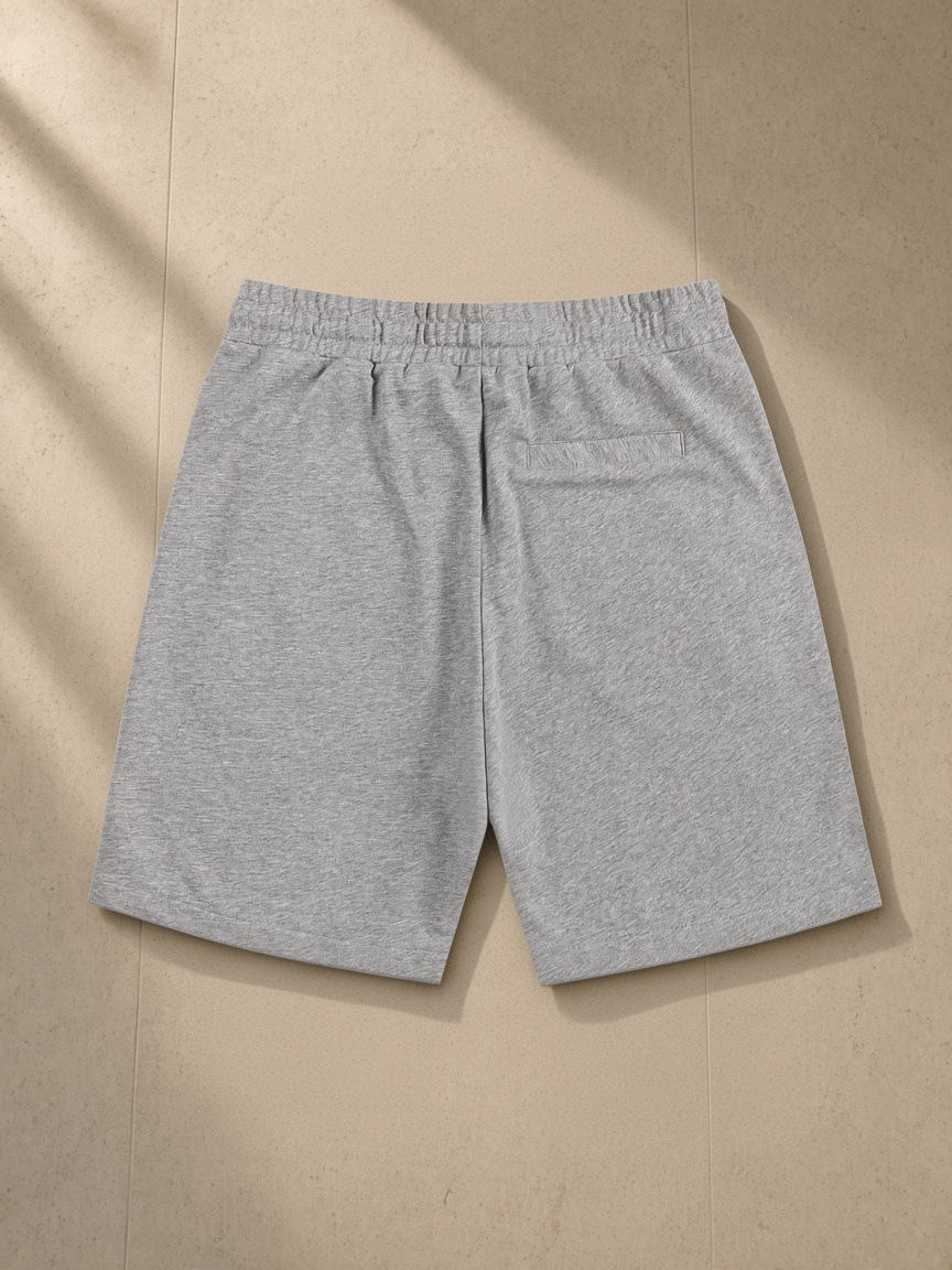Essential Cotton Shorts in Flower Gray, laid flat on pale limestone, back view