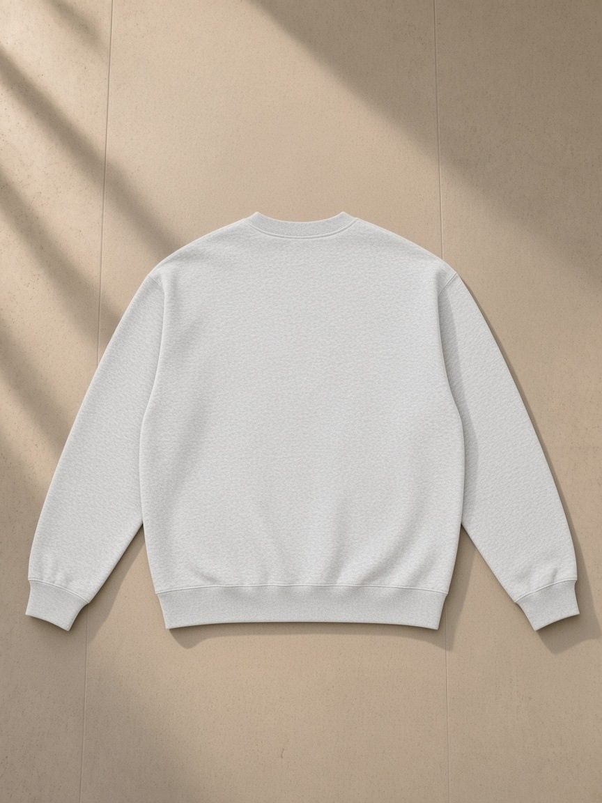 Oversized drop shoulder crewneck sweatshirt in Flower Gray, laid flat on pale limestone, back view