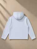 Unisex paneled full zip hoodie in Light Blue, laid flat on pale limestone, back view