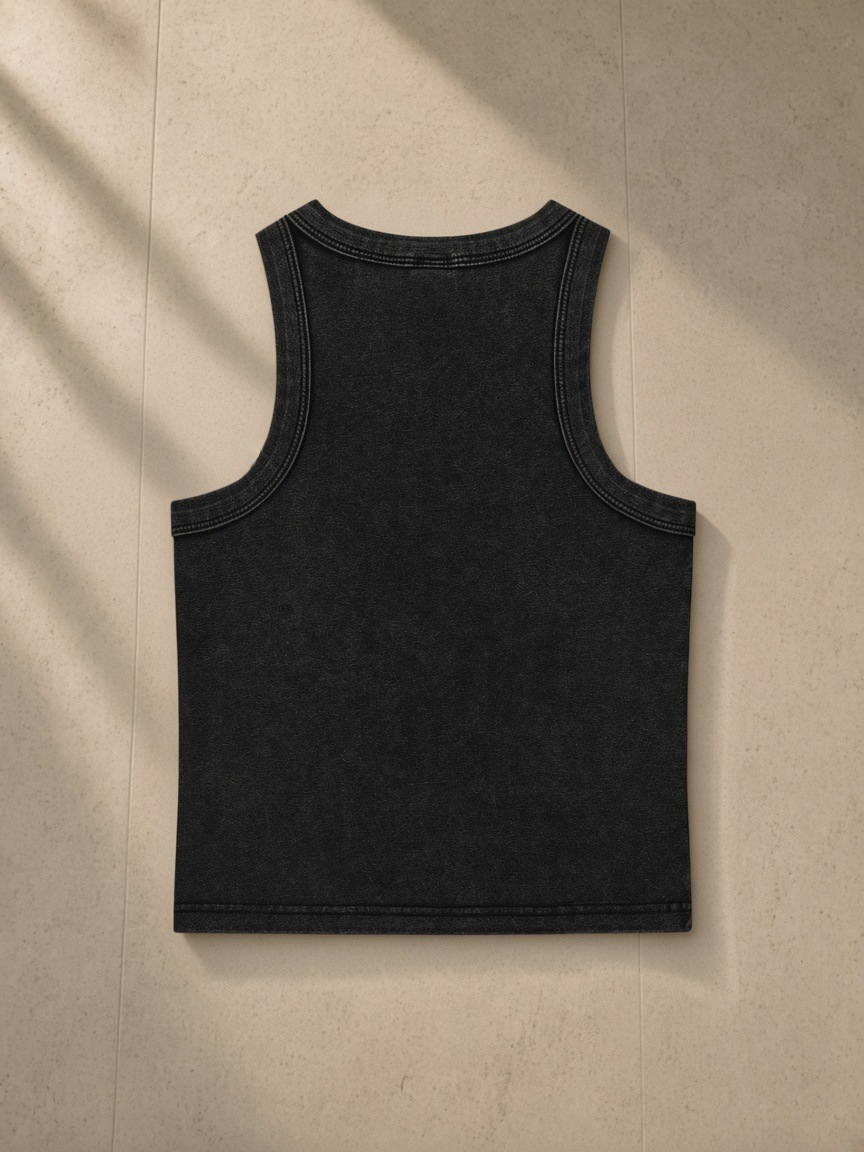 Snow Washed Tank Top in Black, laid flat on pale limestone, back.