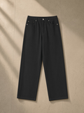 Heavyweight Straight-Leg Trousers in Black, laid flat on pale limestone