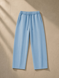 Vintage wash barrel leg fleece sweatpants in Light Blue, laid flat on pale limestone
