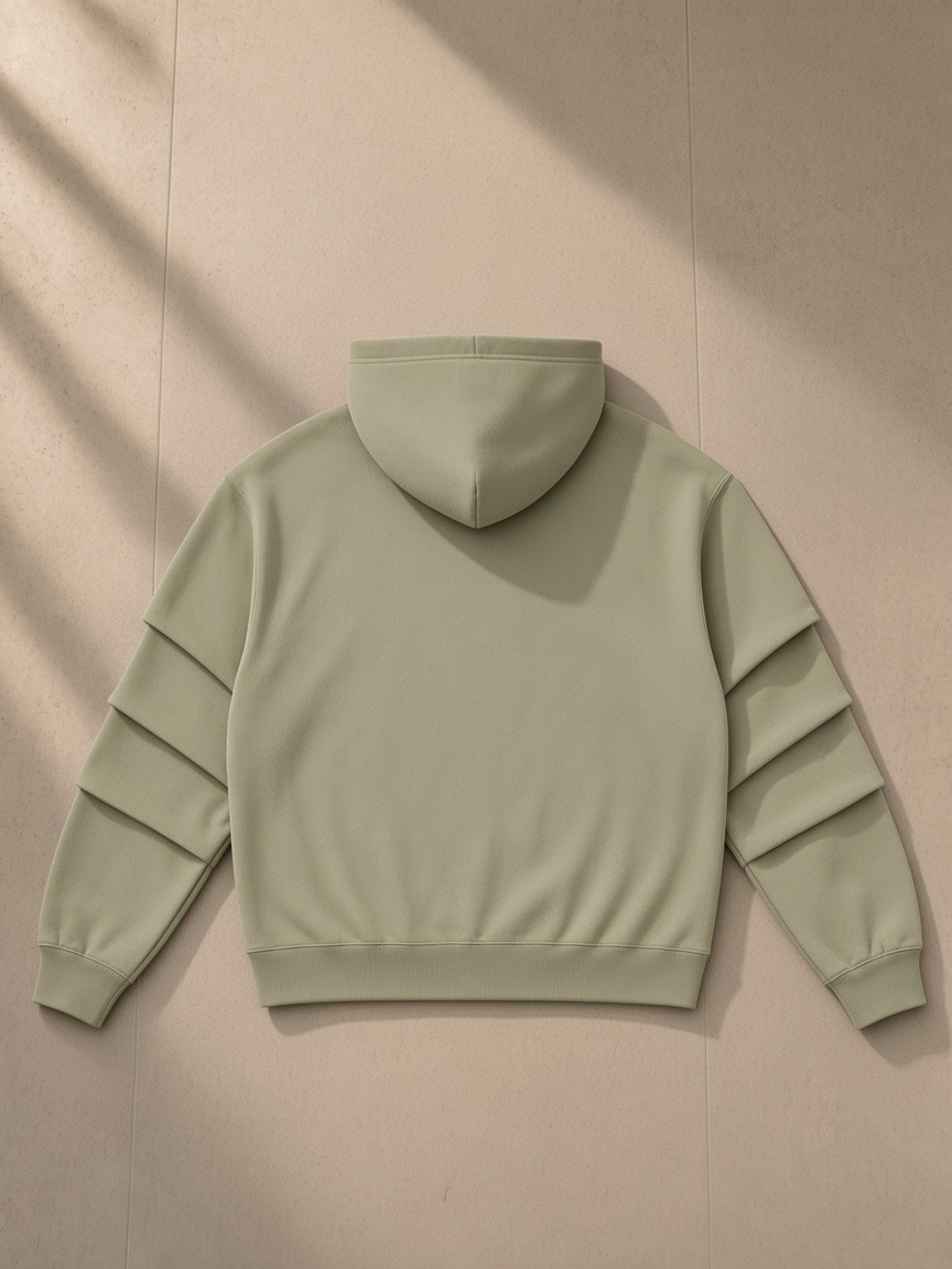 Unisex heavyweight ruched sleeves hoodie in Gray Green, laid flat on pale limestone, back view