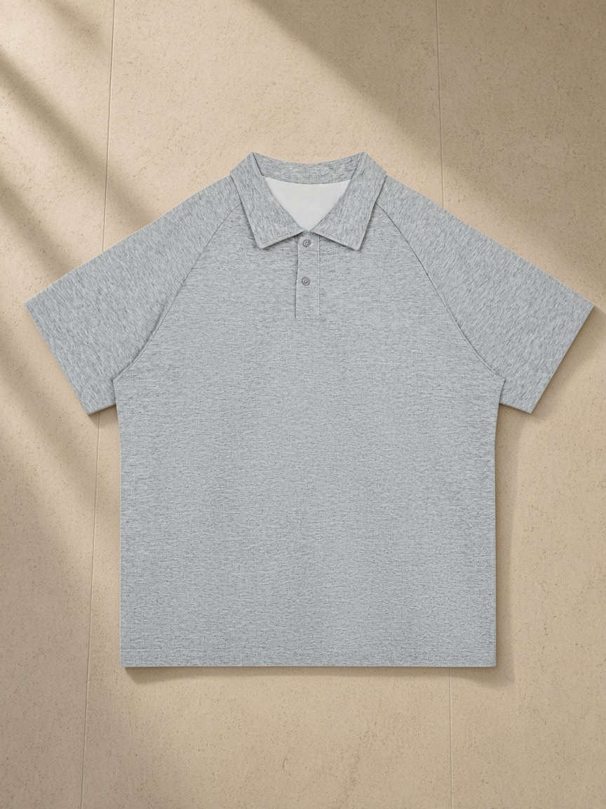 Classic Knit Polo in Flower Gray, laid flat on pale limestone