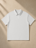 Quarter-Zip Knit Polo in Light Gray, laid flat on pale limestone