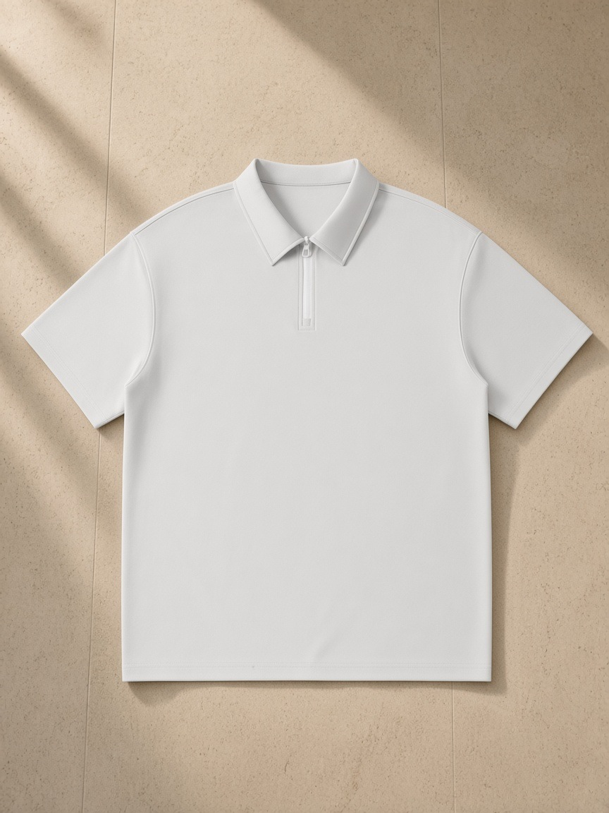Quarter-Zip Knit Polo in Light Gray, laid flat on pale limestone