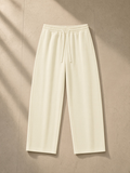 Waffle barrel leg pants in Mild Apricot, laid flat on pale limestone