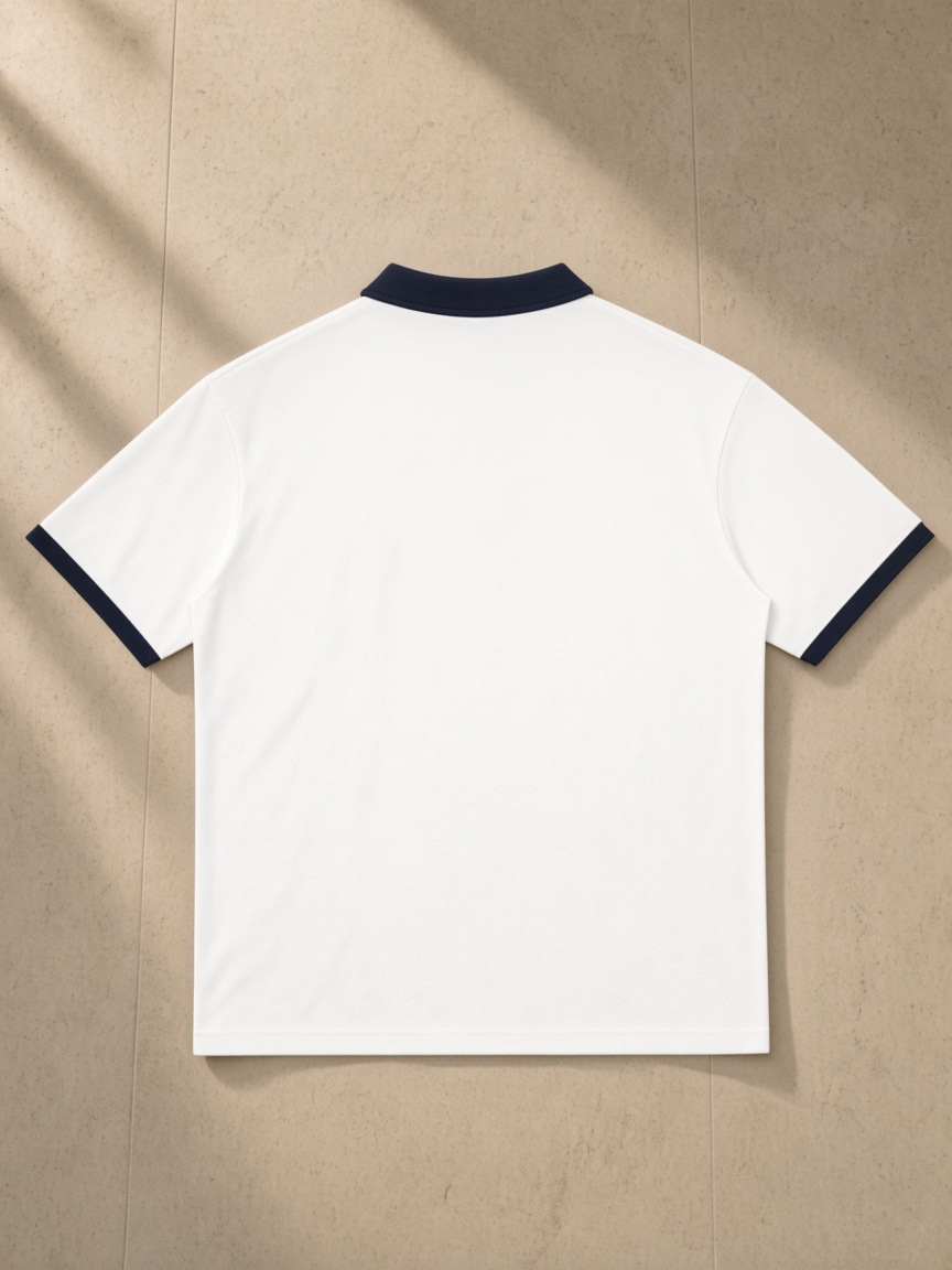 Color Block Polo Shirt in White with Navy Blue, laid flat on pale limestone, back.