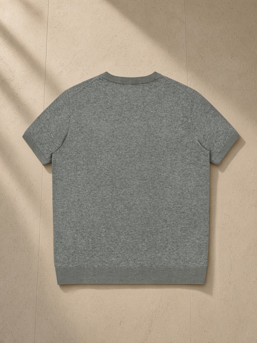 Crewneck Knit T-Shirt in Flower Gray, laid flat on pale limestone, back view