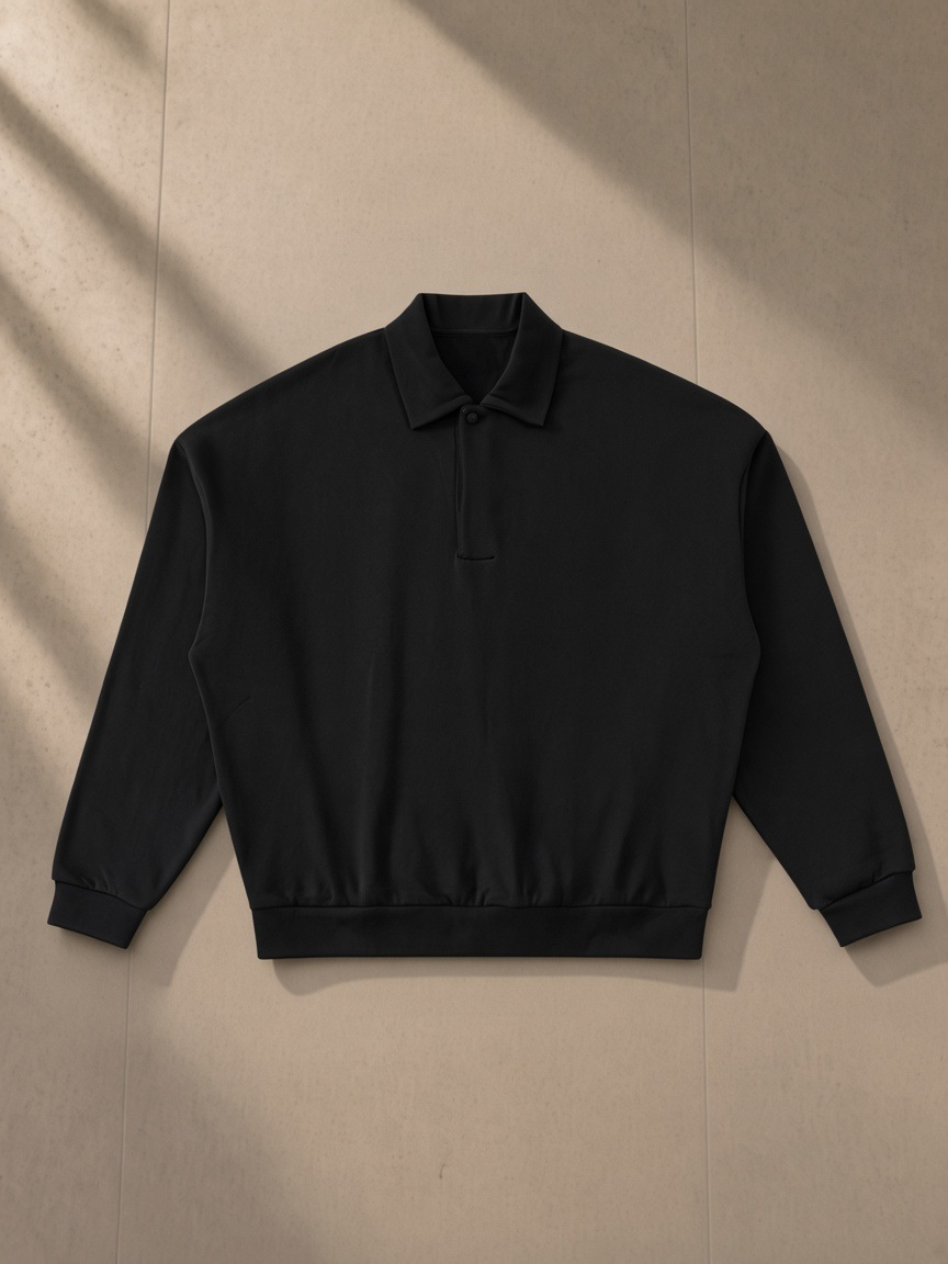 Heavyweight Fleece Polo Sweatshirt — Dark in Black, laid flat on pale limestone, front.