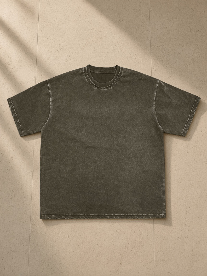 Snow washed raw-edge neckline t-shirt in Clay Gray, laid flat on pale limestone