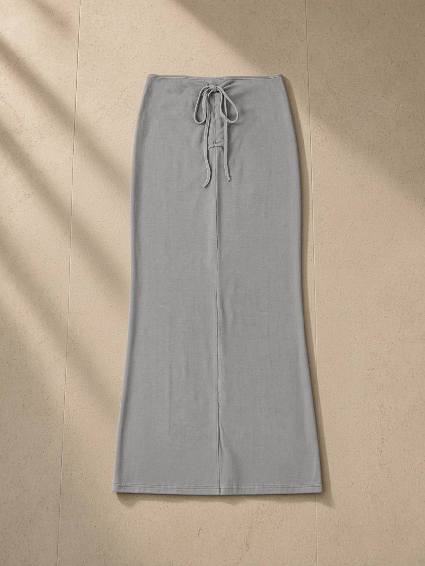 Dyed washed drawstring maxi skirt in Medium Gray, laid flat on pale limestone