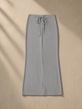 Dyed washed drawstring maxi skirt in Medium Gray, laid flat on pale limestone