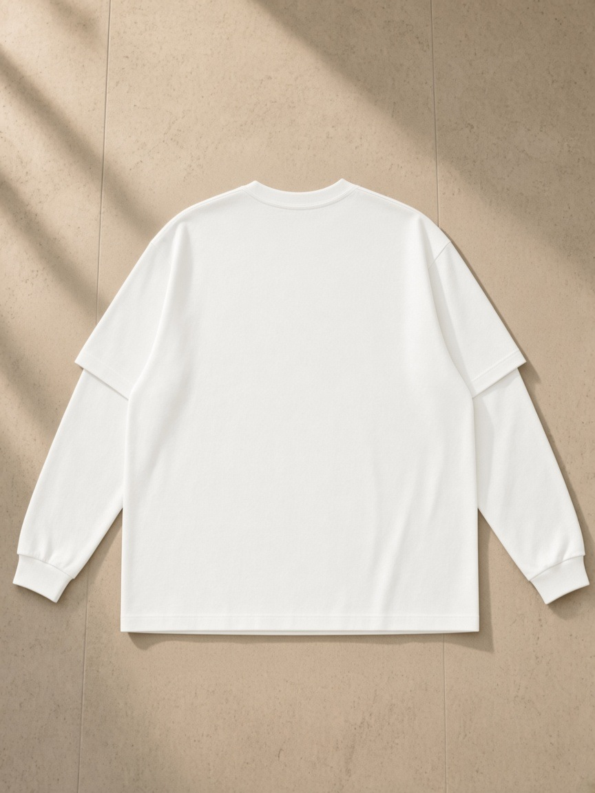 Layered Oversized T-Shirt in White, laid flat on pale limestone, back.