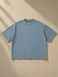 Vintage Wash Boxy T-Shirt in Blue, laid flat on pale limestone