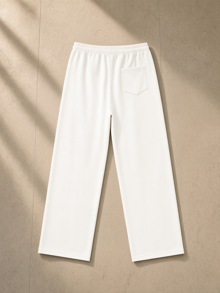 Straight Leg Sweatpants in White, laid flat on pale limestone, back.