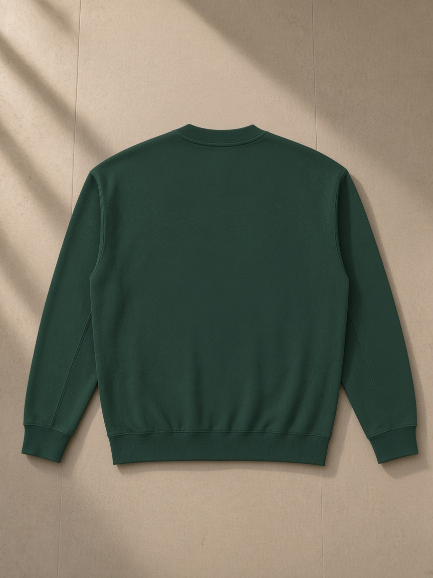 Drop Shoulder Crewneck Sweatshirt in Retro Green, laid flat on pale limestone, back view