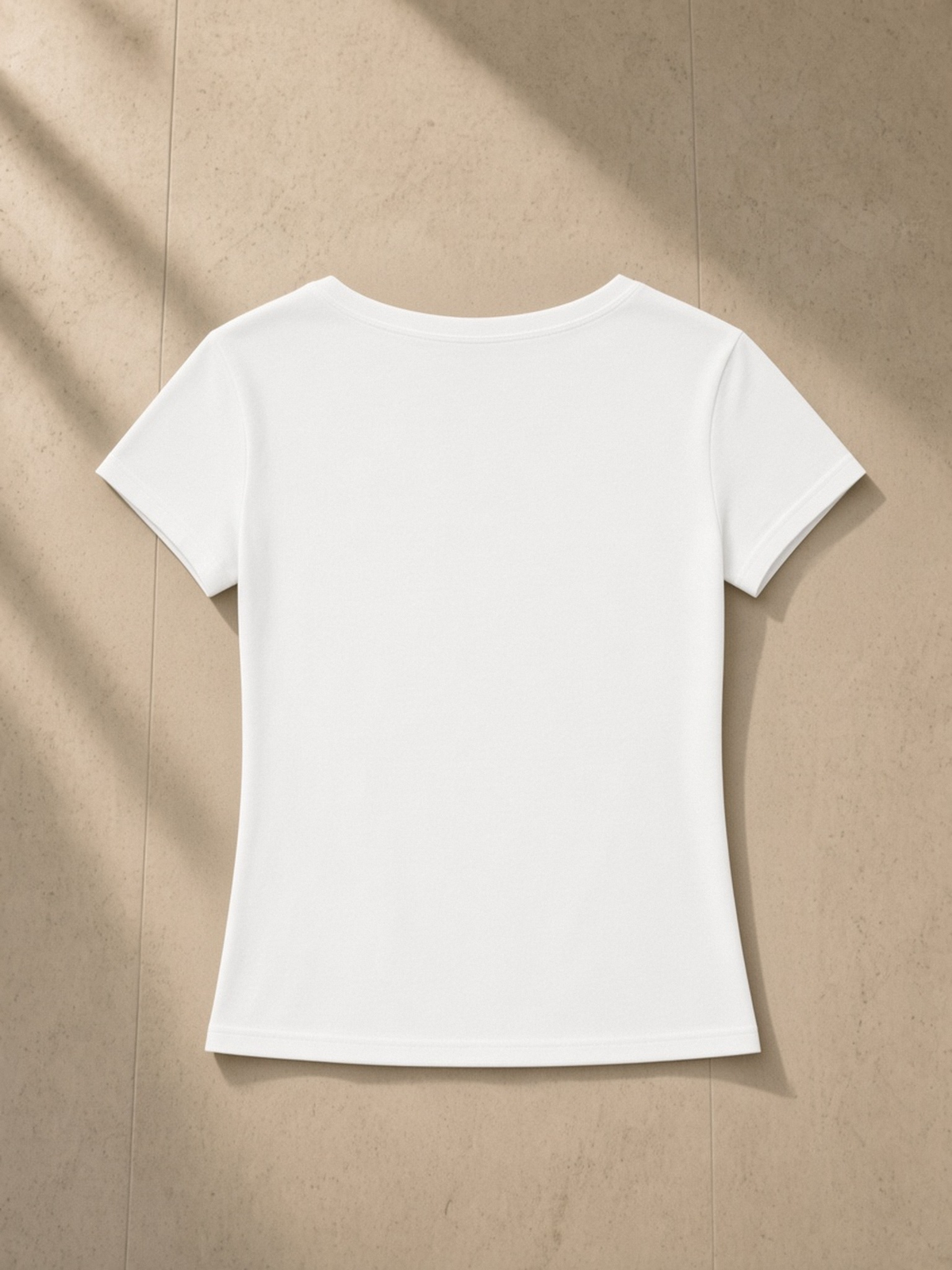 Tencel Slim Fit V-Neck T-Shirt in White, laid flat on pale limestone, back.