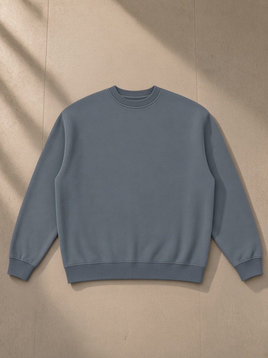 Vintage Wash Fleece Sweatshirt — Dark in Washed Blue, laid flat on pale limestone, front.