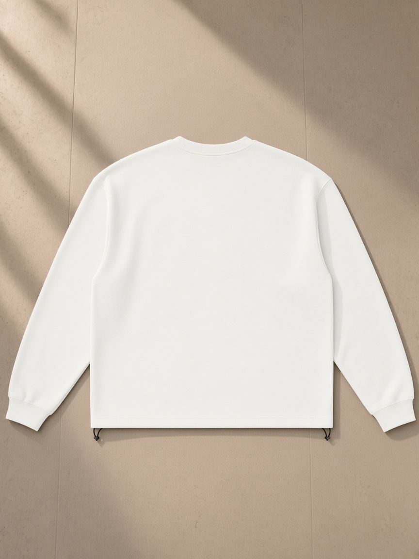 Heavyweight oversized boxy sweatshirt in White, laid flat on pale limestone, back view